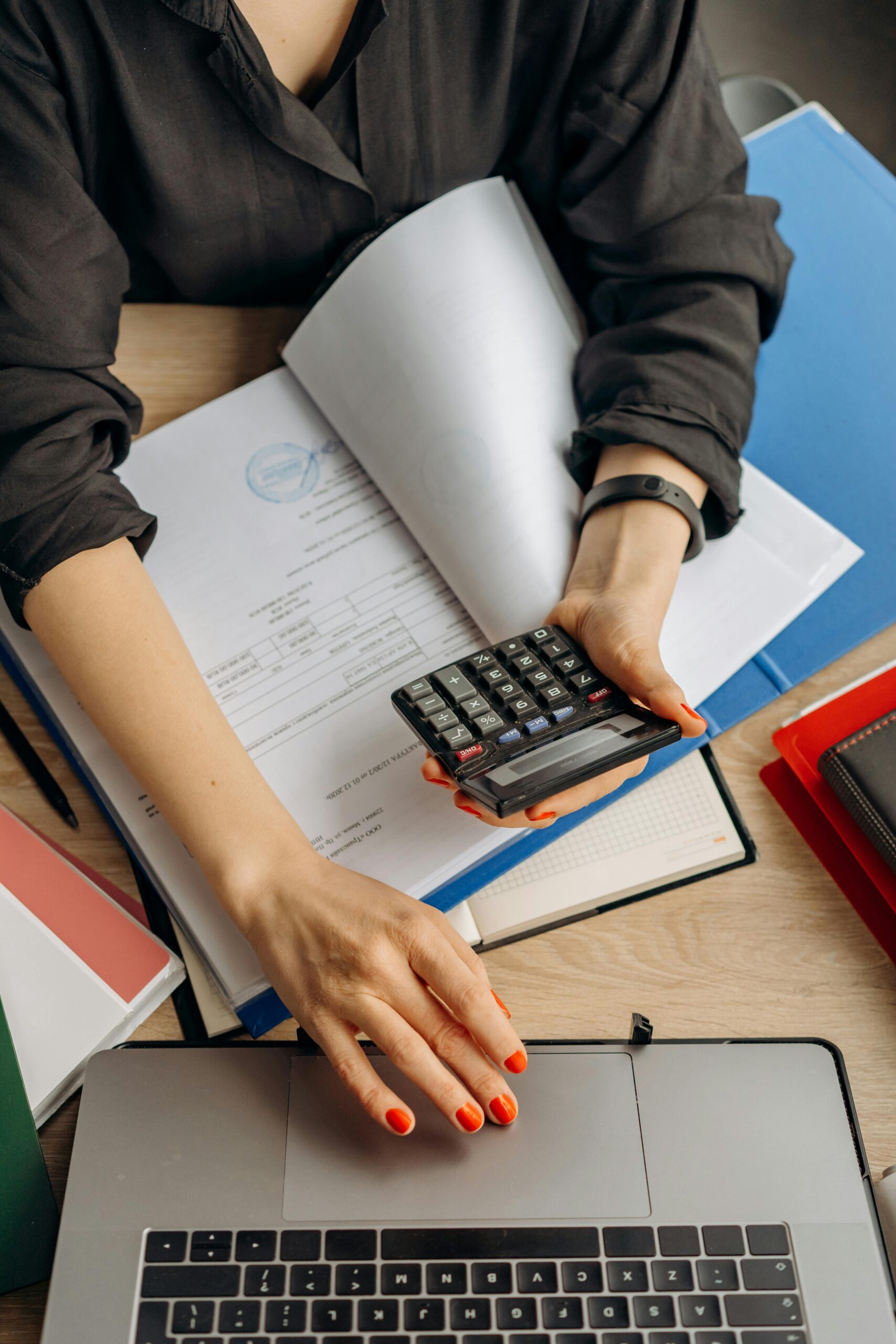 A lady holding a calculator while preparing a quote.
